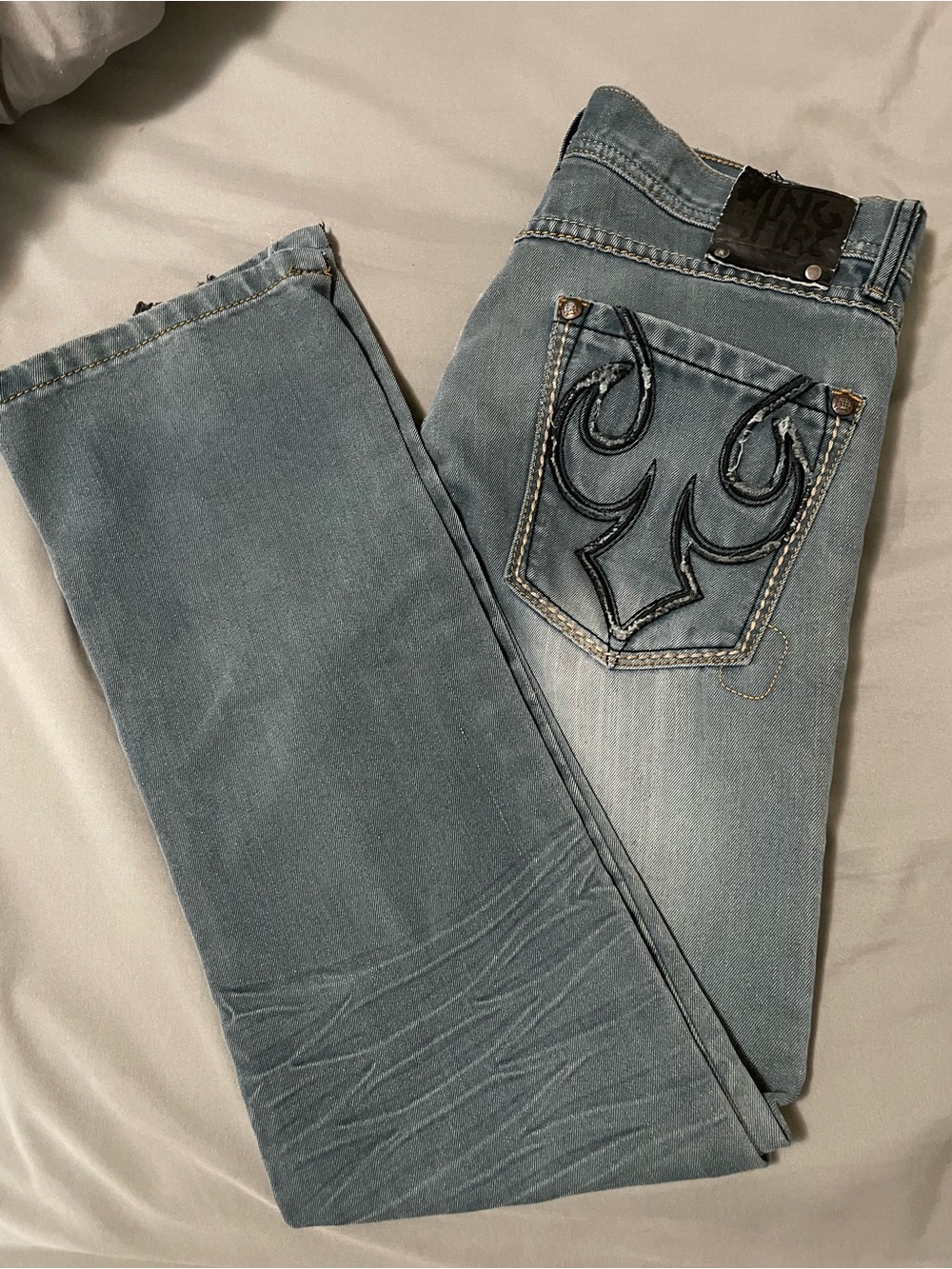 Distressed light stone washed denim jeans